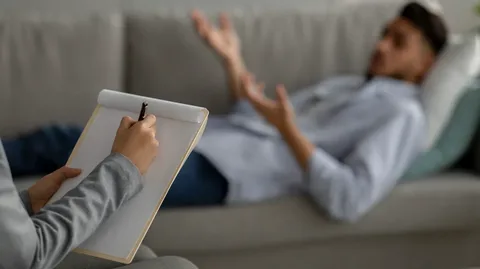 Therapist supporting patient